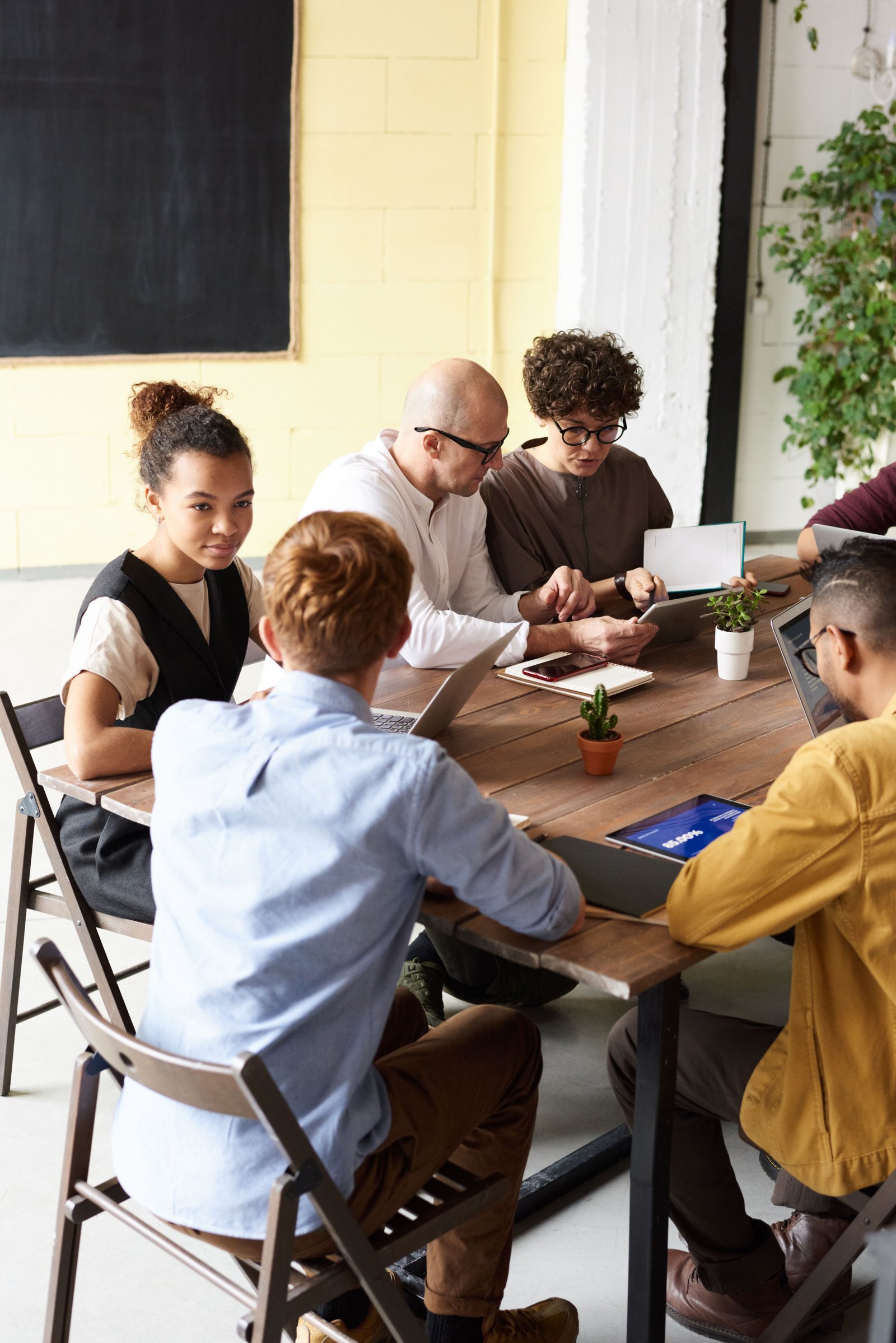 A team collaborating around a table, discussing a project together.